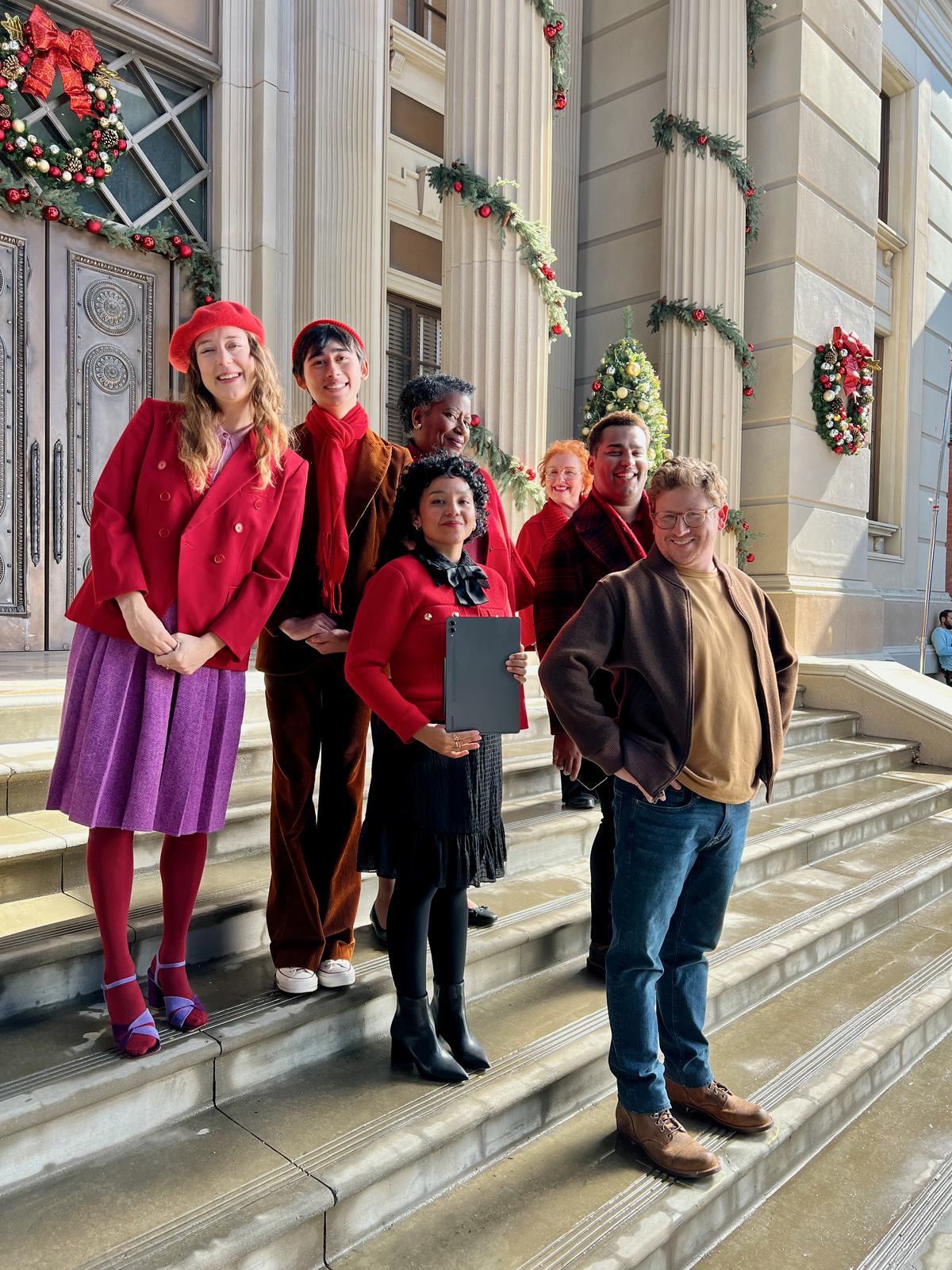 The carolers in wardrobe on the set steps